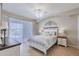 Well-lit main bedroom with decorative headboard, tile floors, and sliding glass doors at 2105 Deborah Dr, Punta Gorda, FL 33950