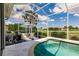 Private screened pool with an umbrella and lounge seating at 2105 Deborah Dr, Punta Gorda, FL 33950