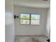 A bright bedroom features a window overlooking exterior landscape at 214 W Grace St, Punta Gorda, FL 33950