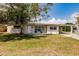Inviting single-Gathering home with a tidy lawn, carport, and a mature shade tree on the property at 214 W Grace St, Punta Gorda, FL 33950