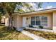 Charming single-story home featuring a well-maintained lawn and mature shade tree in front at 214 W Grace St, Punta Gorda, FL 33950