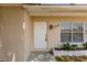 Close-up of the house entrance highlighting the front door, house number, and adjacent window at 214 W Grace St, Punta Gorda, FL 33950