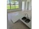 Kitchen featuring stainless steel sink and view to outdoors at 214 W Grace St, Punta Gorda, FL 33950
