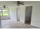 Expansive living area with ceiling fans and natural light, offering flexibility for furniture arrangement at 214 W Grace St, Punta Gorda, FL 33950
