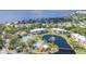 Community aerial view showcasing pond, tennis courts, swimming pool and beautiful landscaping at 23465 Harborview Rd # 214, Punta Gorda, FL 33980