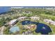 Community aerial view showcasing pond, tennis courts, swimming pool and beautiful landscaping at 23465 Harborview Rd # 214, Punta Gorda, FL 33980