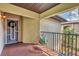 Cozy covered balcony with a chair, offering a private outdoor space with views of the lush surrounding landscape at 23465 Harborview Rd # 214, Punta Gorda, FL 33980