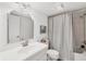 Well-lit bathroom featuring a vanity, toilet, and shower with a curtain at 23465 Harborview Rd # 214, Punta Gorda, FL 33980
