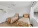 Bright bedroom featuring twin beds, wood-look floors, and a closet at 23465 Harborview Rd # 214, Punta Gorda, FL 33980