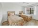 Cozy bedroom with two twin beds, wood-look flooring, and a ceiling fan at 23465 Harborview Rd # 214, Punta Gorda, FL 33980