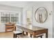 Bright dining area with a wooden table, barstool seating, and view into the adjacent kitchen at 23465 Harborview Rd # 214, Punta Gorda, FL 33980