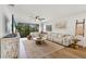 Bright living room with a large sectional, modern decor, and an abundance of natural light at 23465 Harborview Rd # 214, Punta Gorda, FL 33980