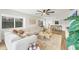Spacious living room with modern furniture, a large window with shutters, and bright, neutral decor at 23465 Harborview Rd # 214, Punta Gorda, FL 33980