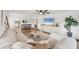 Cozy living room featuring stylish furniture, a large TV, and seamless flow to the adjacent dining and kitchen areas at 23465 Harborview Rd # 214, Punta Gorda, FL 33980