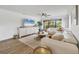 Bright and inviting living room featuring stylish decor, a large window, and comfortable seating at 23465 Harborview Rd # 214, Punta Gorda, FL 33980