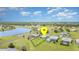 Beautiful aerial view of the home situated on a large lot near a lake and green space in a planned community at 24348 Nicobar Ln, Punta Gorda, FL 33955