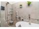 Accessible bathroom featuring a soaking tub with grab bars and adjustable shower fixtures at 24348 Nicobar Ln, Punta Gorda, FL 33955