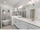 Elegant bathroom with dual sinks, a large mirror, and a separate soaking tub at 24348 Nicobar Ln, Punta Gorda, FL 33955