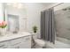 Modern bathroom featuring a tub with shower, neutral tile, and contemporary fixtures at 24348 Nicobar Ln, Punta Gorda, FL 33955