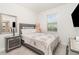 Cozy bedroom featuring a comfortable bed, neutral tones, and a sunny window at 24348 Nicobar Ln, Punta Gorda, FL 33955