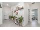 Bright foyer featuring tile floors, neutral walls, decorative shelving, and a view of the living spaces at 24348 Nicobar Ln, Punta Gorda, FL 33955