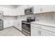 Bright kitchen showcasing white cabinetry, stainless steel appliances, and modern countertops at 24348 Nicobar Ln, Punta Gorda, FL 33955