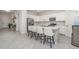 Modern kitchen featuring white cabinets, stainless steel appliances, a large island, and bar stool seating at 24348 Nicobar Ln, Punta Gorda, FL 33955