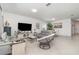 Large living room featuring neutral walls, tile floors, modern furniture, and view into the kitchen at 24348 Nicobar Ln, Punta Gorda, FL 33955