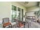 Relaxing patio with seating, a table, and a swing, perfect for outdoor lounging at 24348 Nicobar Ln, Punta Gorda, FL 33955