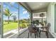 Screened-in patio with seating, a dining table, and view of the expansive backyard at 24348 Nicobar Ln, Punta Gorda, FL 33955