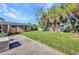 Large backyard with brick pavers and lush landscaping, creating a serene outdoor retreat at 25082 Harborview Rd, Punta Gorda, FL 33980