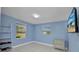Bright bedroom featuring a wall mounted television and view of outside at 25082 Harborview Rd, Punta Gorda, FL 33980