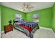 Bright bedroom featuring a ceiling fan, bedside table and view of outside at 25082 Harborview Rd, Punta Gorda, FL 33980
