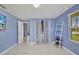 Bright bedroom featuring a open closet and view of outside at 25082 Harborview Rd, Punta Gorda, FL 33980