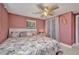 Inviting bedroom with pink walls, comfortable bed, and neutral toned bedding, creating a cozy atmosphere at 25082 Harborview Rd, Punta Gorda, FL 33980