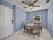 Dining area features modern ceiling fan, gray color scheme and view of outside at 25082 Harborview Rd, Punta Gorda, FL 33980