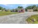 A charming single-story home with a concrete driveway and a well-maintained front yard at 25082 Harborview Rd, Punta Gorda, FL 33980