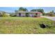 A well-maintained single-story home with a simple landscape, a lush lawn, and a traditional design at 25082 Harborview Rd, Punta Gorda, FL 33980