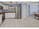 The kitchen has stainless steel appliances, white cabinetry, and an open layout, perfect for cooking at 25082 Harborview Rd, Punta Gorda, FL 33980
