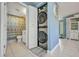 Convenient laundry area featuring a stackable washer and dryer adjacent to the bathroom at 25082 Harborview Rd, Punta Gorda, FL 33980