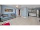 The living room boasts blue walls, tile floors, and an open layout leading into the kitchen at 25082 Harborview Rd, Punta Gorda, FL 33980