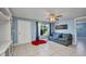 Bright living room with tile floors, blue walls, modern ceiling fan, and a comfortable sofa at 25082 Harborview Rd, Punta Gorda, FL 33980