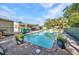 A backyard with a fenced pool and landscaped with plants, offering a relaxing and private outdoor space at 25082 Harborview Rd, Punta Gorda, FL 33980