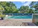 Beautiful backyard pool surrounded by a well-maintained brick patio and lush landscaping at 25082 Harborview Rd, Punta Gorda, FL 33980