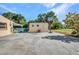 Spacious backyard featuring a storage shed, a basketball hoop, and room for various outdoor activities at 25082 Harborview Rd, Punta Gorda, FL 33980