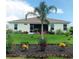 Landscaped backyard featuring a charming garden and screened-in porch with comfortable seating at 25224 Lahore Ln, Punta Gorda, FL 33983