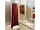 Bathroom with granite countertop vanity and a bathtub with a shower behind a red curtain at 25224 Lahore Ln, Punta Gorda, FL 33983