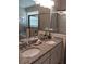 Bathroom features a dual granite vanity, soaking tub, glass shower and decorative flowers at 25224 Lahore Ln, Punta Gorda, FL 33983