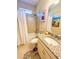Bathroom includes a granite vanity, white shower curtain and tub-shower combo, and whimsical decor at 25224 Lahore Ln, Punta Gorda, FL 33983