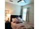 This bedroom features a ceiling fan, window, and plush bedding for a cozy and inviting space at 25224 Lahore Ln, Punta Gorda, FL 33983
